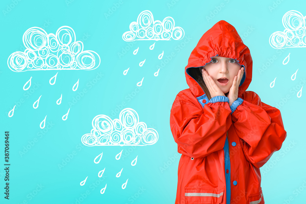 Surprised little girl in raincoat on color background with drawn clouds and drops