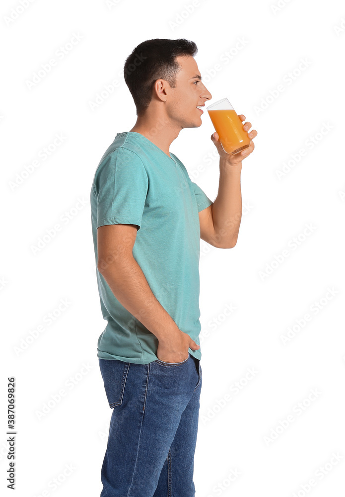 Handsome man with orange juice on white background