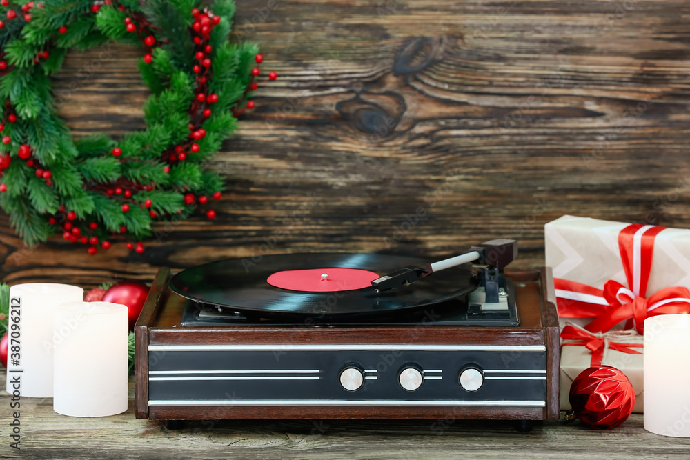 Record player and Christmas decor on table