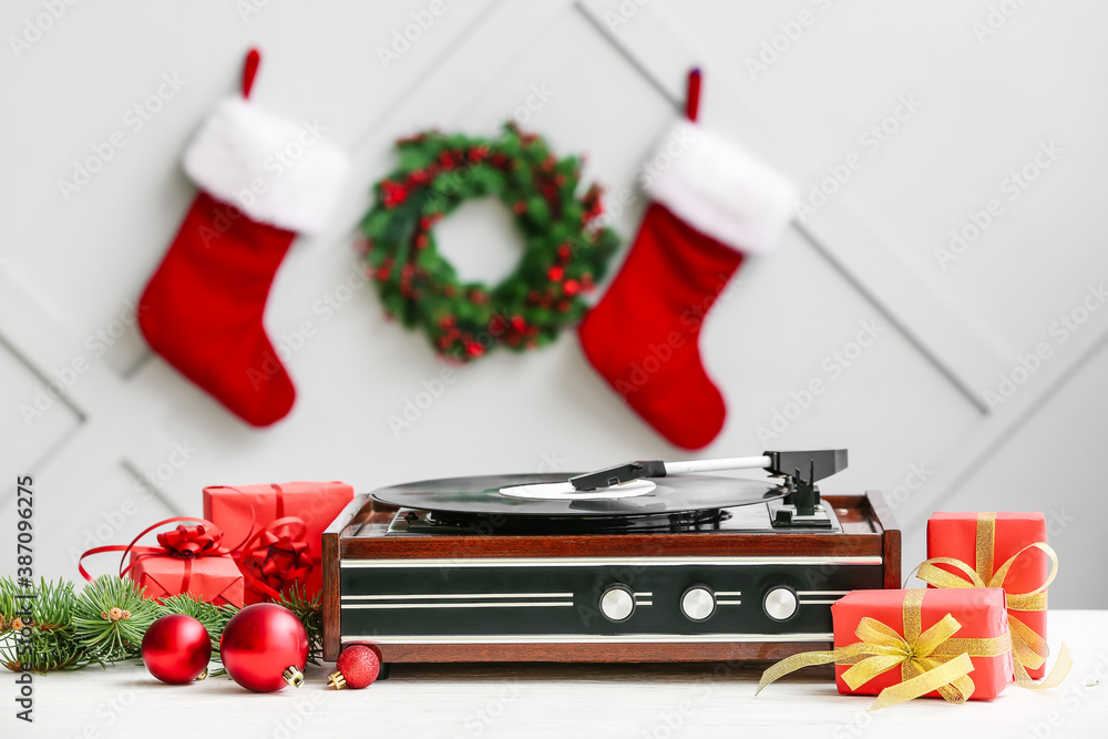 Record player and Christmas decor on table