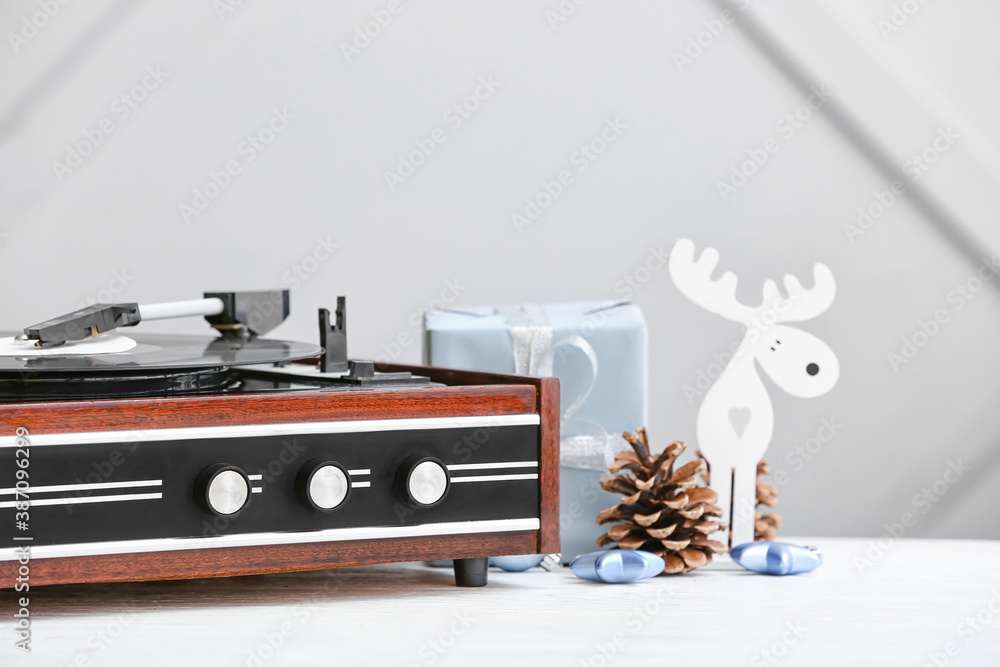 Record player and Christmas decor on table