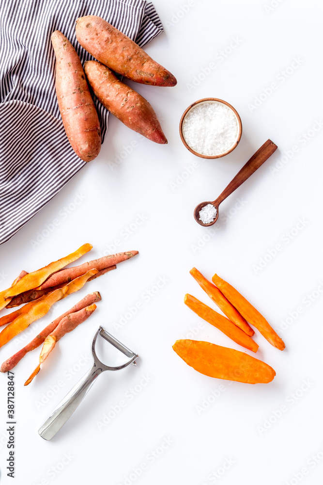 Overhead view of sweet potato sliced on kitchen board. Top view