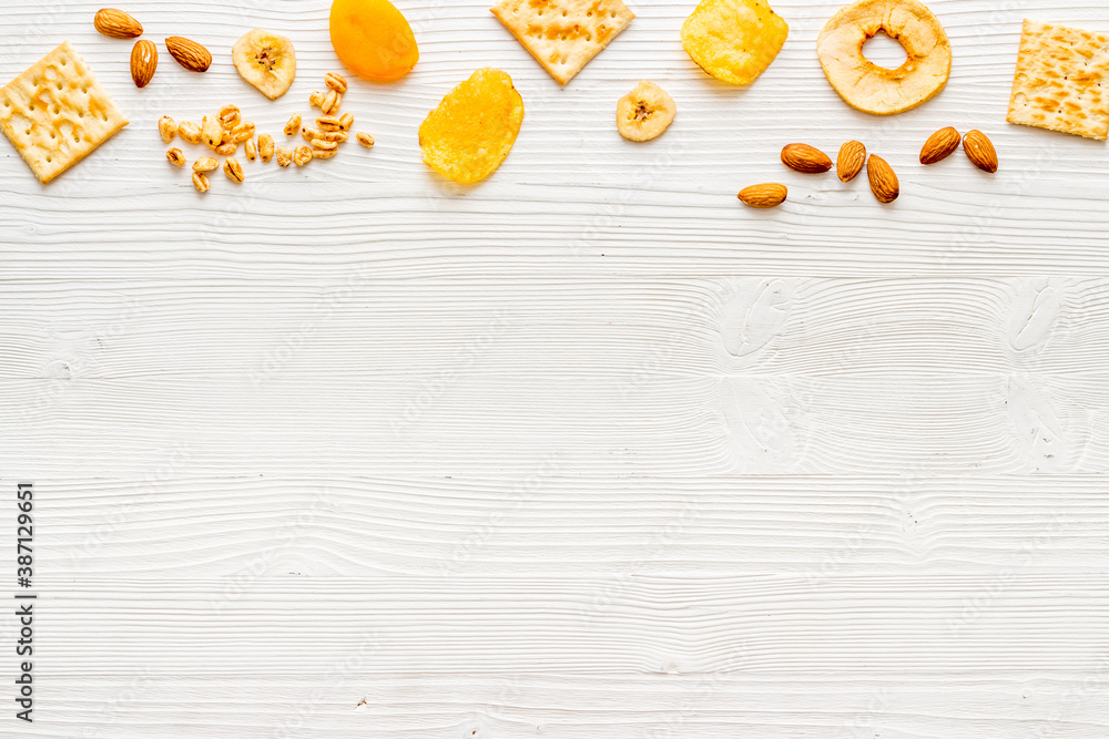 Healthy snacks overhead - nuts and dried fruits with crackers