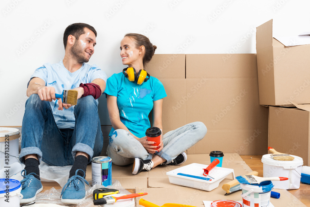 Happy couple together sitting on floor