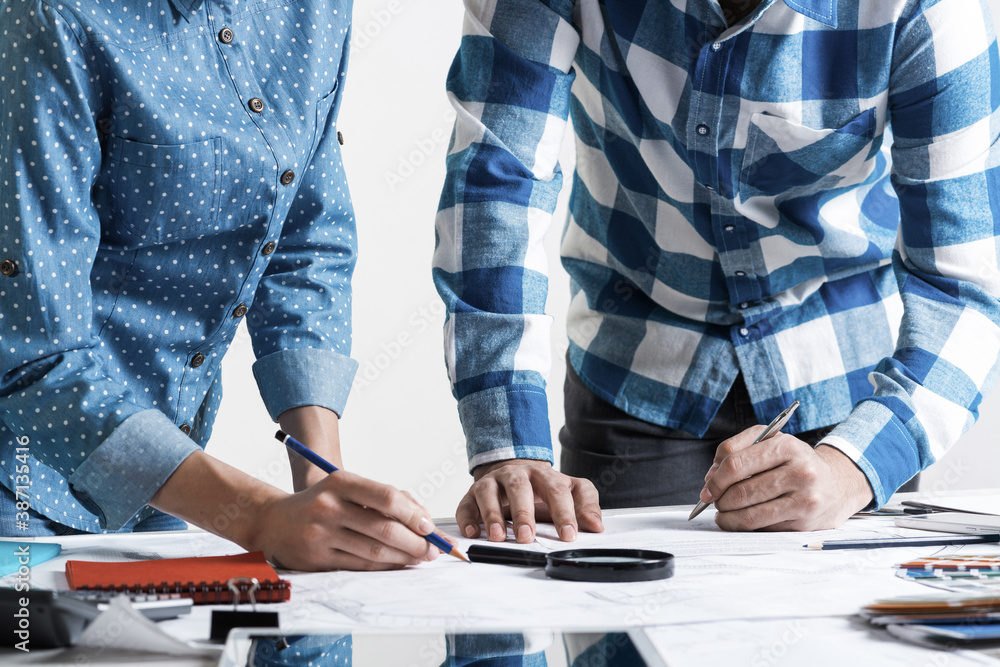 Man writing with pen on technical drawing