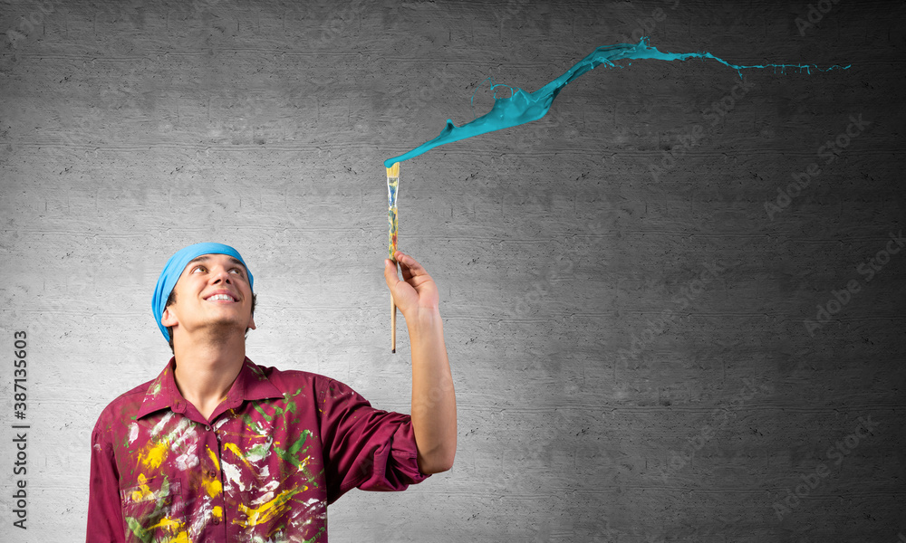 Young artist painting blue brush stroke