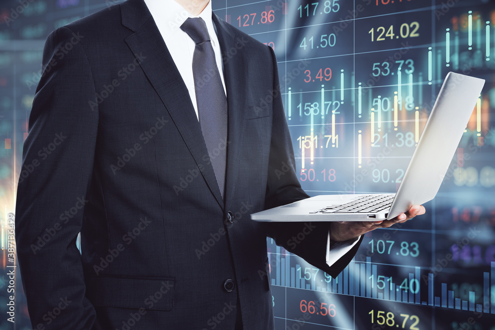 Businessman with laptop on a financial chart background, double exposure, trading concept