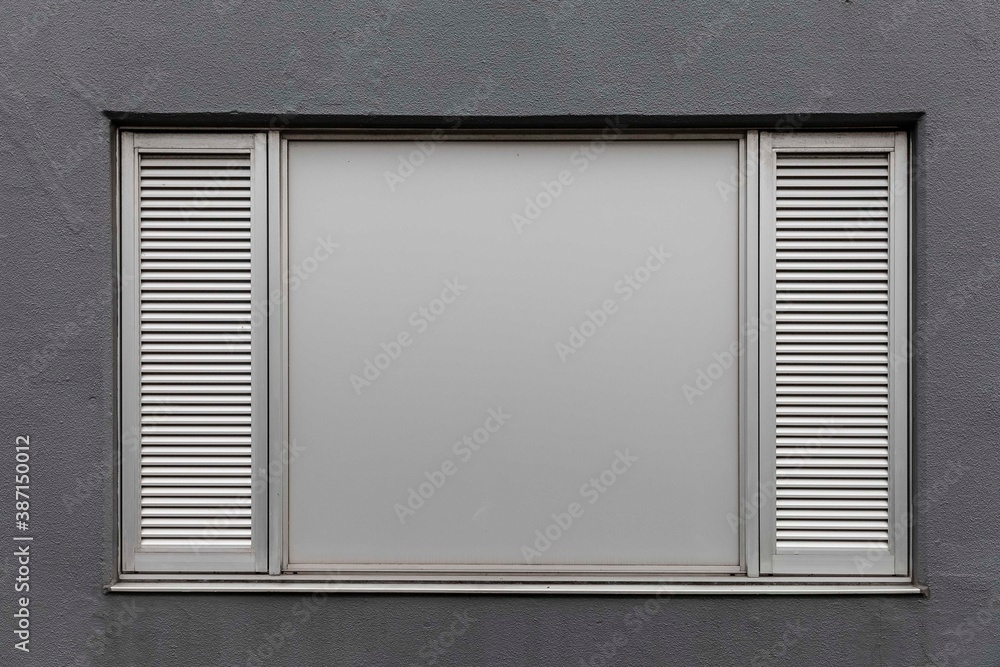 Silver aluminum windows on gray cement wall