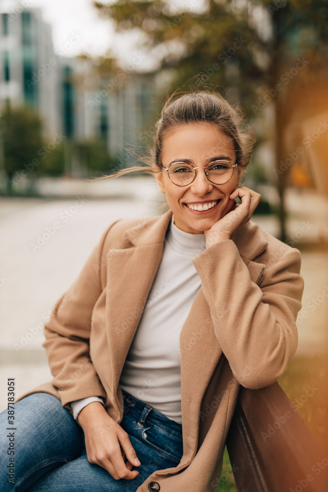 Wearing glasses, dressed elegant.