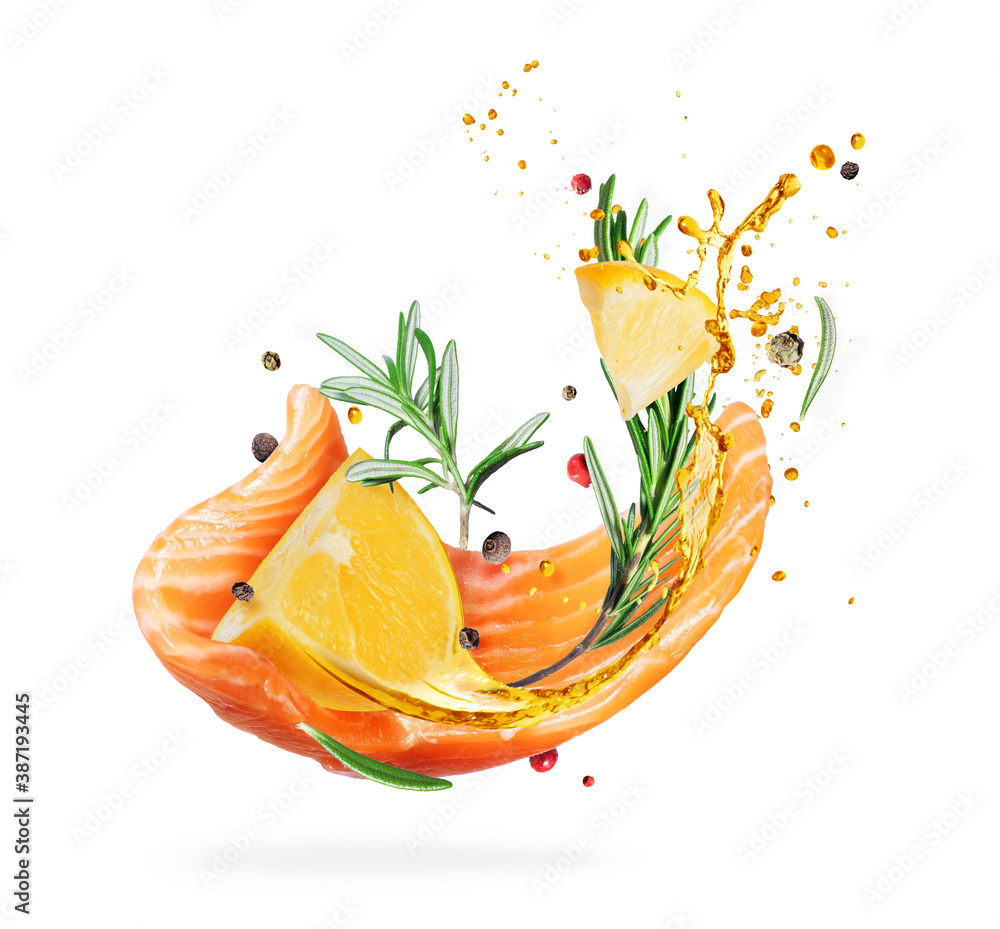 Slice of fresh salmon with flavored spices and lemon in the air, isolated on a white background