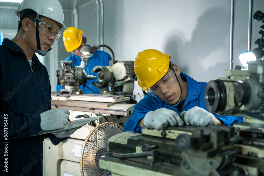 Mechanic working in the factory,The industrial worker team is working at a industrial factory.