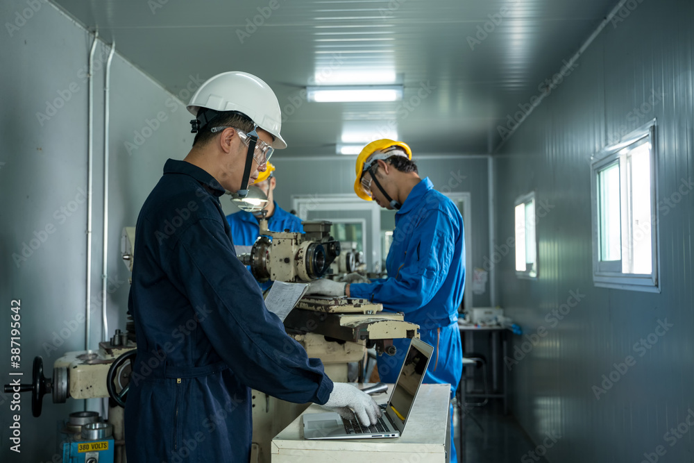 The industrial worker team working in factory with the machine.