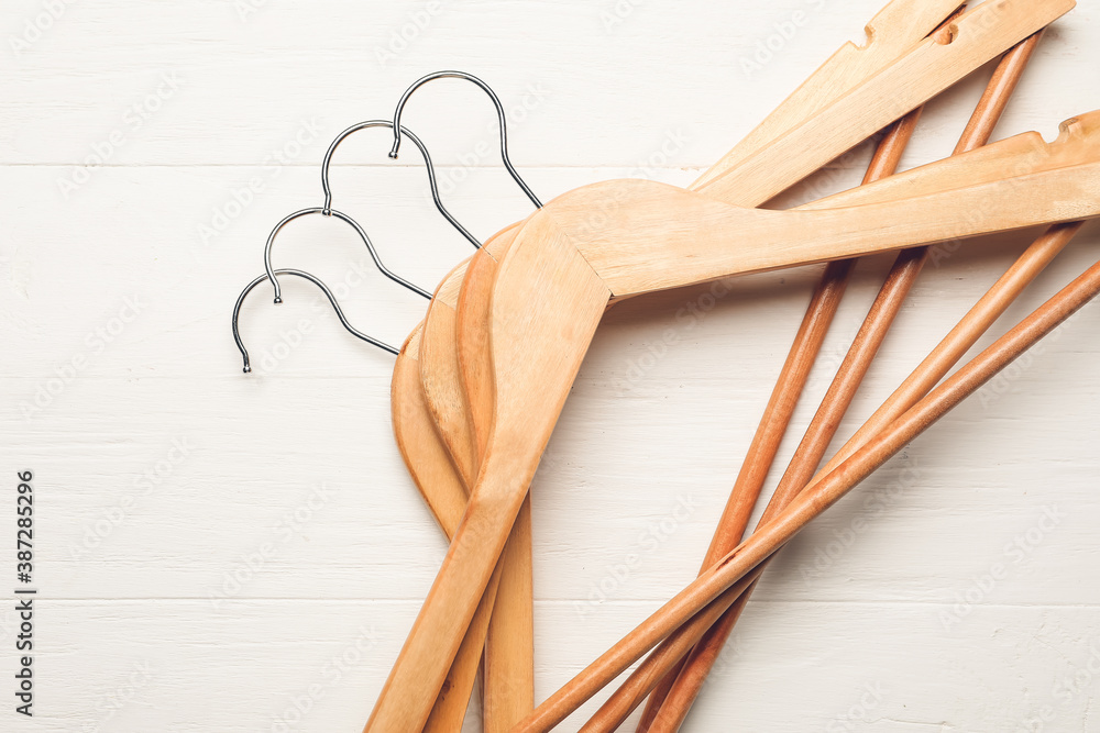 Clothes hangers on wooden background