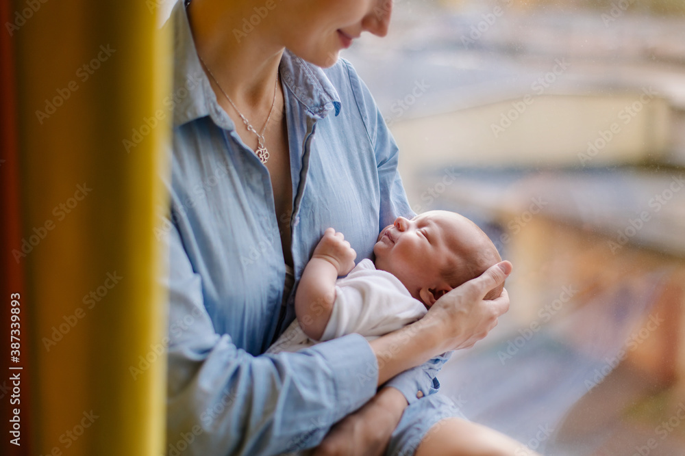 mother rocks the child. Portrait of a sleeping newborn in mothers arms. Caring love tenderness. Mot