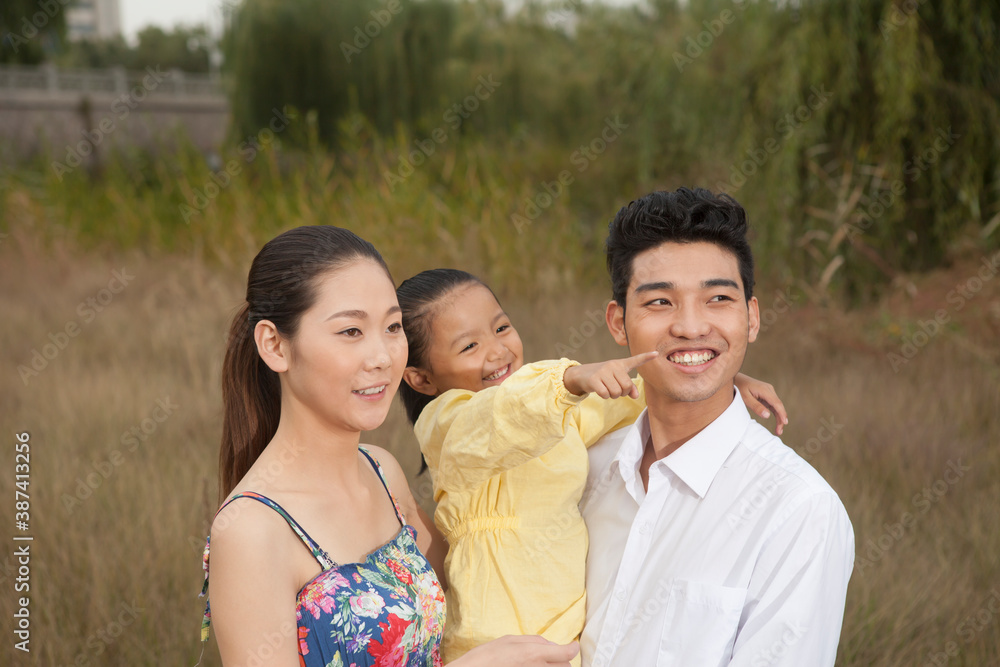 A happy family of three in the park for an outing