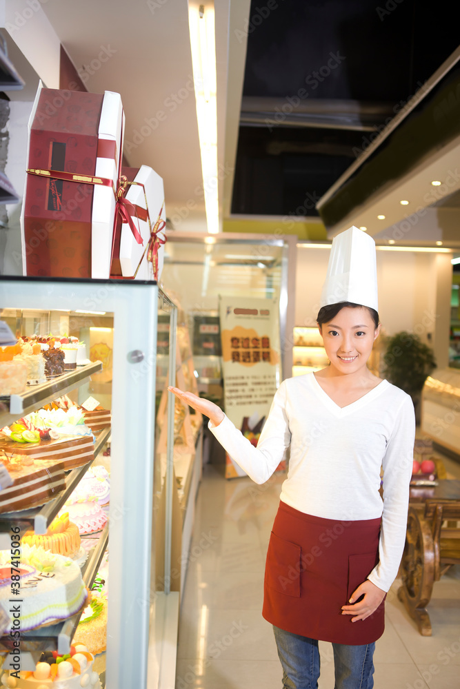 The happy bakery saleswoman is in the bakery