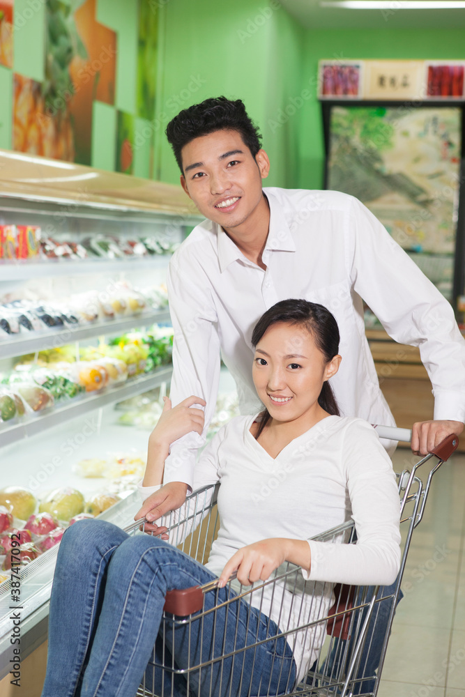 A young couple in the supermarket shopping