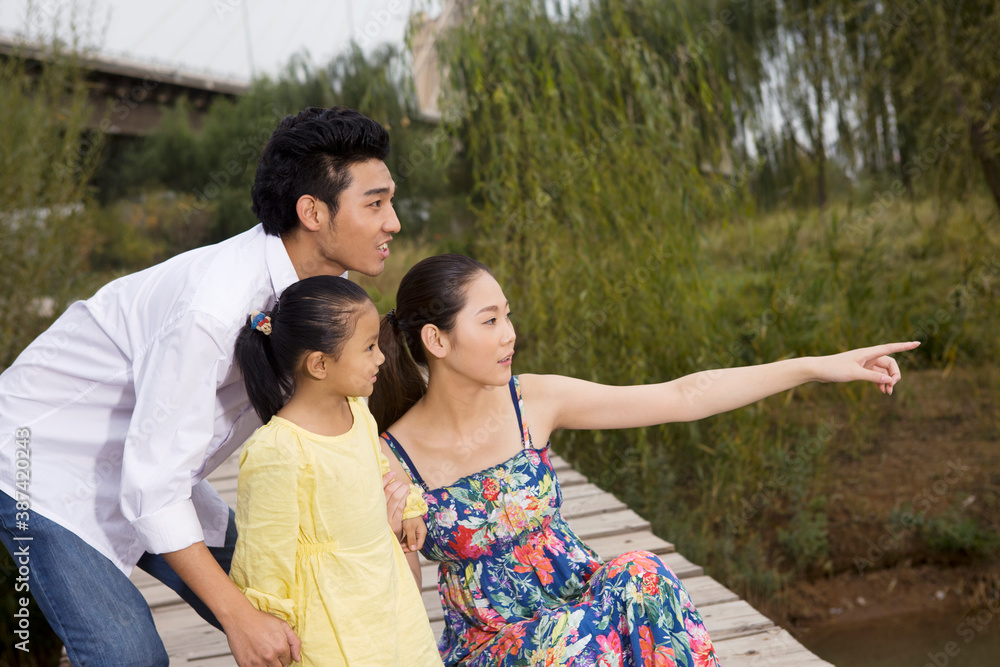 A happy family of three in the park for an outing