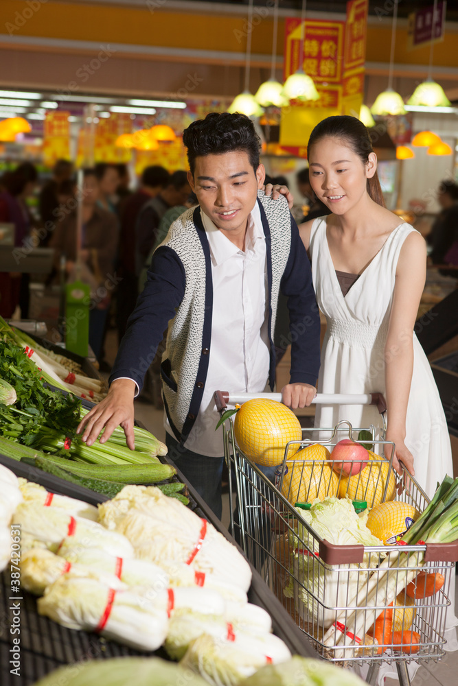 A young couple in the supermarket shopping