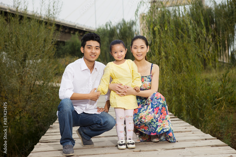 A happy family of three in the park for an outing