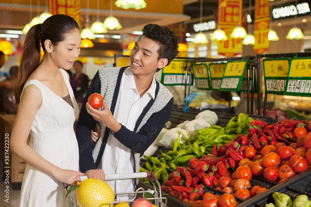 A young couple in the supermarket shopping