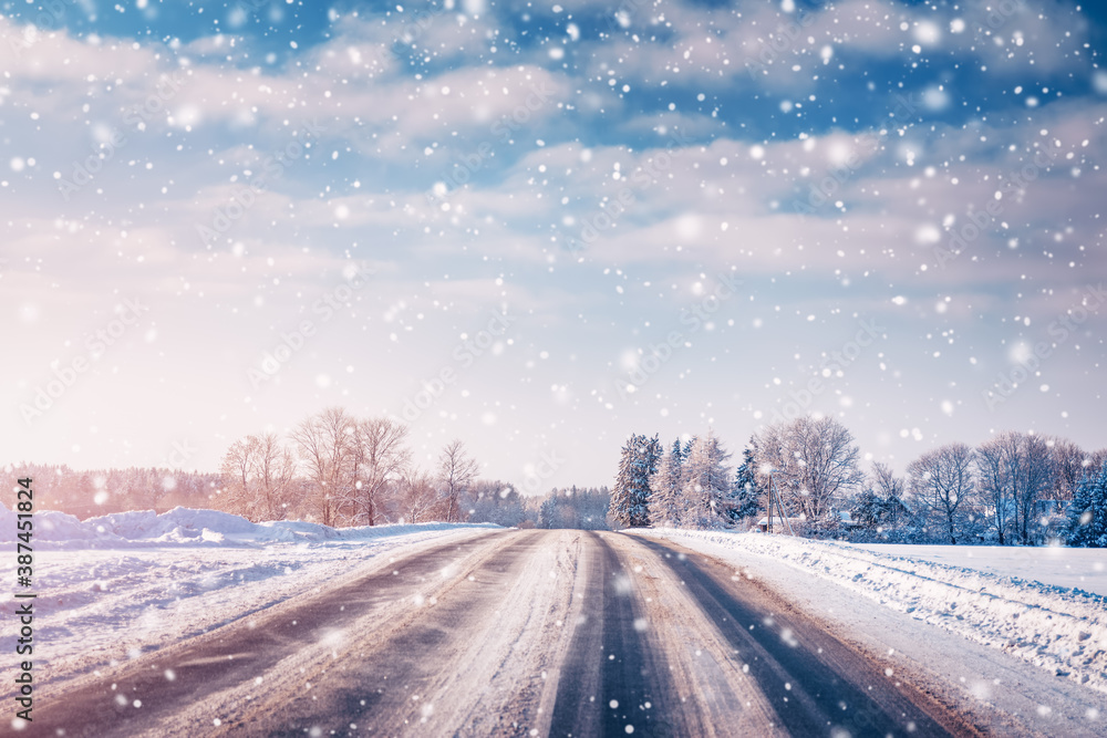 Winter road with snow with trees all around in snowfall