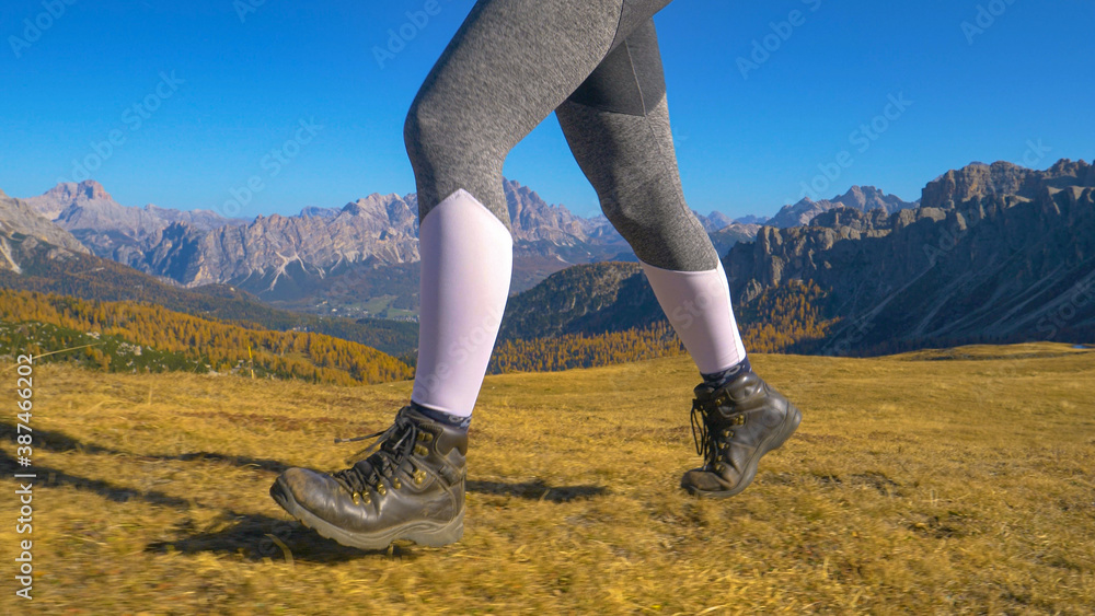 LOW ANGLE: Unrecognizable fit woman goes hiking in the picturesque Dolomites.