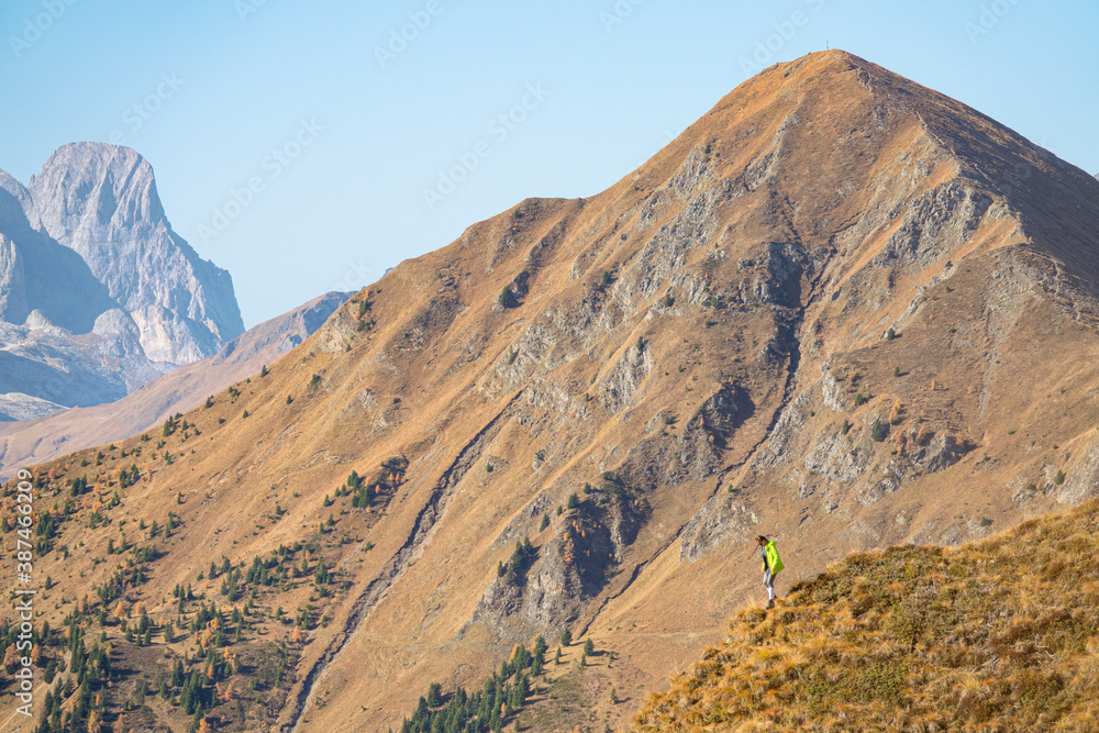 COPY SPACE: Spectacular view of woman during her descent along a grassy mountain