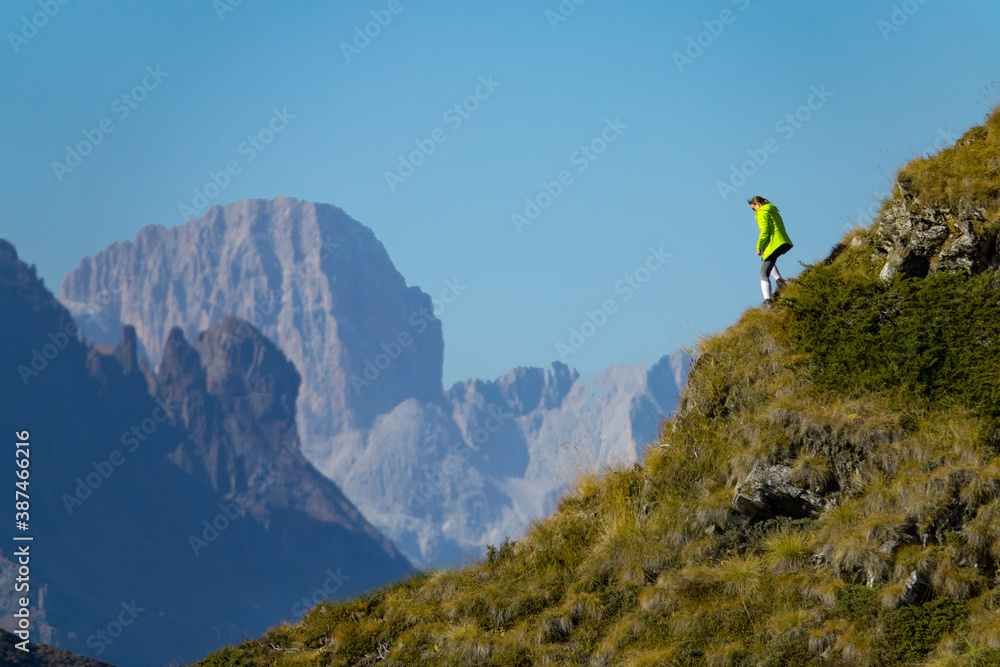 COPY SPACE: Athletic tourist goes hiking in the Dolomites on a sunny autumn day.