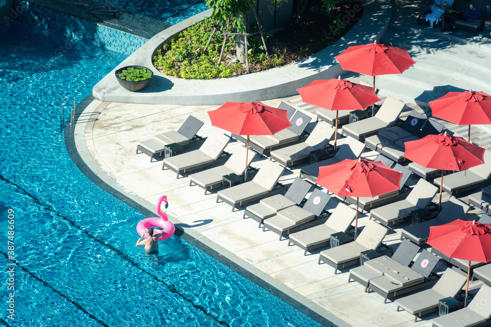 Top view of pool in hotel with daybed. background concept for relaxation and tourist destination