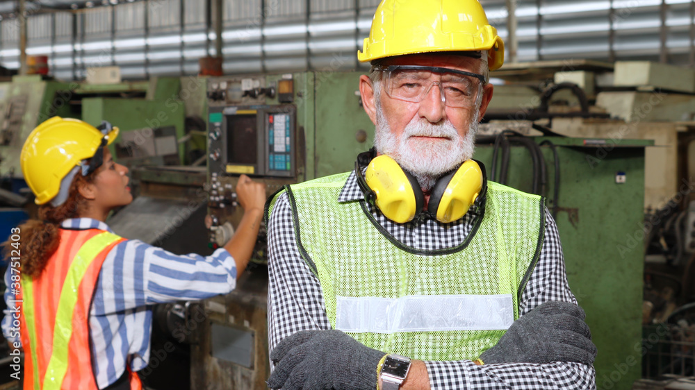 Senior factory worker or engineer close up portrait in factory . Industry and engineering concept .