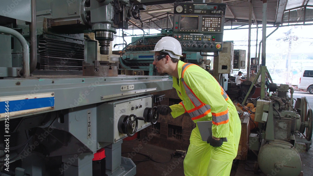 Smart factory worker using machine in factory workshop . Industry and engineering concept.