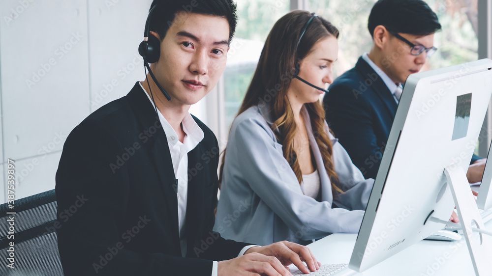 Business people wearing headset working in office to support remote customer or colleague. Call cent