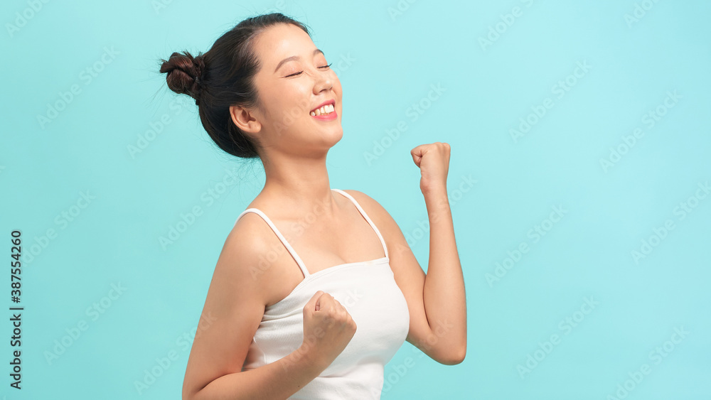 Image of shocked surprised young lady isolated over blue background. Looking camera.