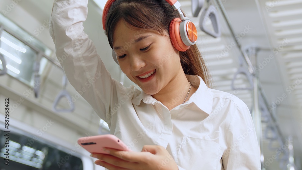 Young woman mobile phone on public train . Urban city lifestyle commuting concept .