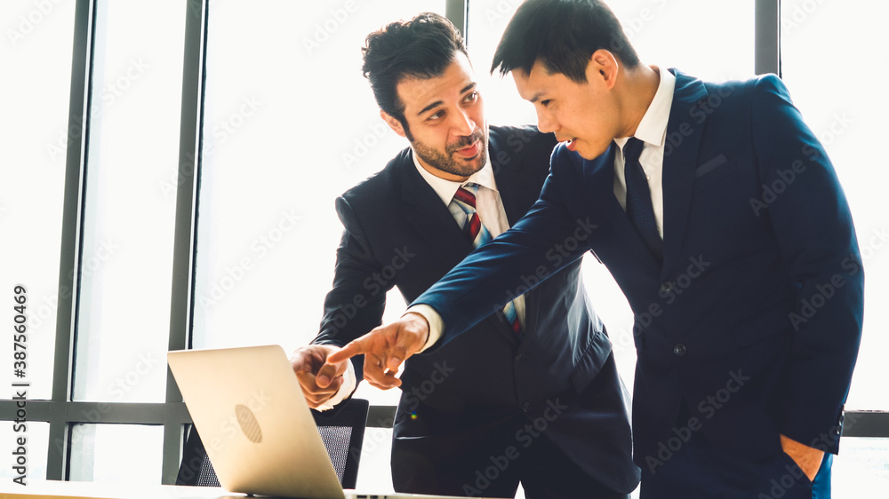 Two business people talk project strategy at office meeting room. Businessman discuss project planni