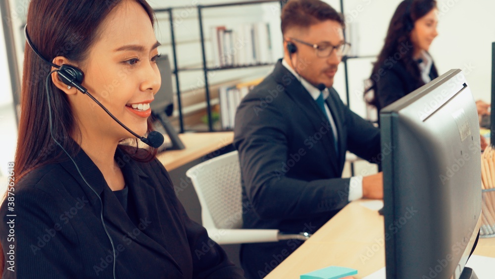 Business people wearing headset working in office to support remote customer or colleague. Call cent