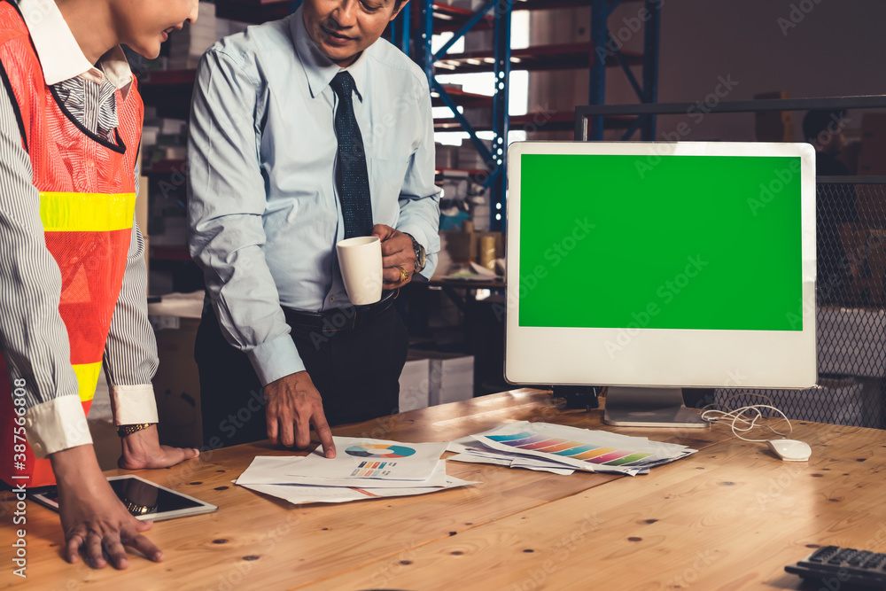 Computer with green screen display in warehouse storage room . Delivery and transportation software 