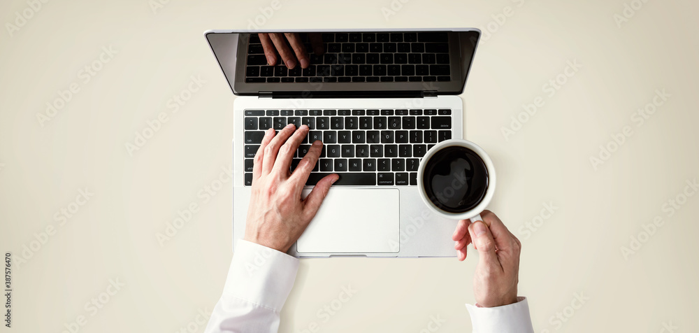 Businessman using a laptop computer overhead view