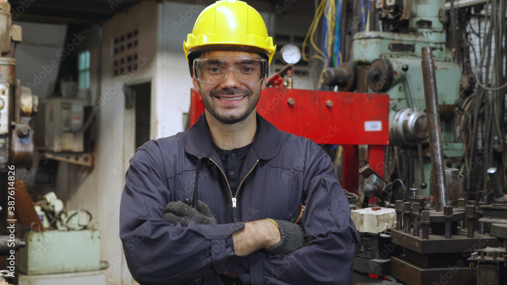 Young factory worker or engineer close up portrait in factory . Industry and engineering concept .