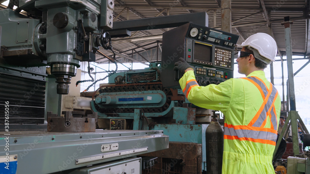 Smart factory worker using machine in factory workshop . Industry and engineering concept.