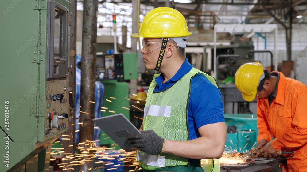 Smart factory worker using machine in factory workshop . Industry and engineering concept.