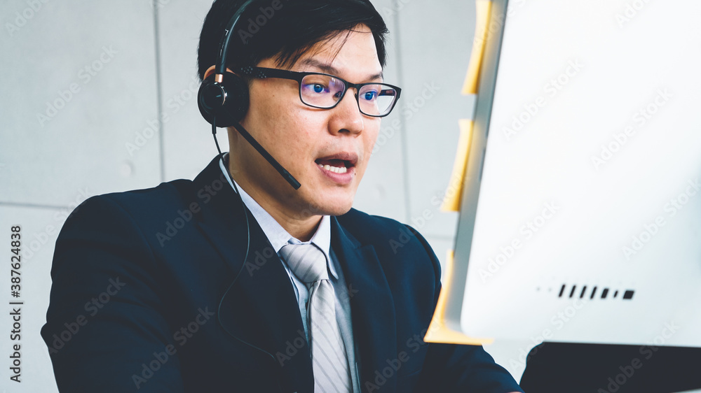 Business people wearing headset working in office to support remote customer or colleague. Call cent