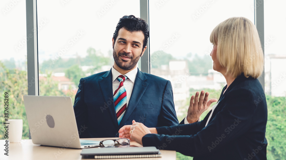 Two business people talk project strategy at office meeting room. Businessman discuss project planni