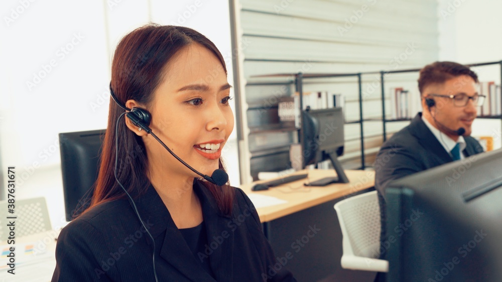 Business people wearing headset working in office to support remote customer or colleague. Call cent