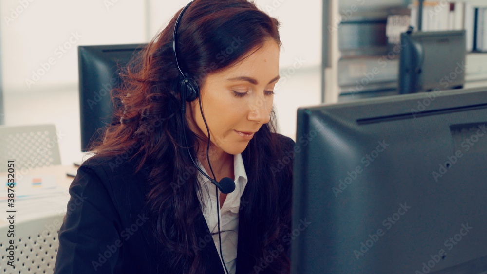 Business people wearing headset working in office to support remote customer or colleague. Call cent