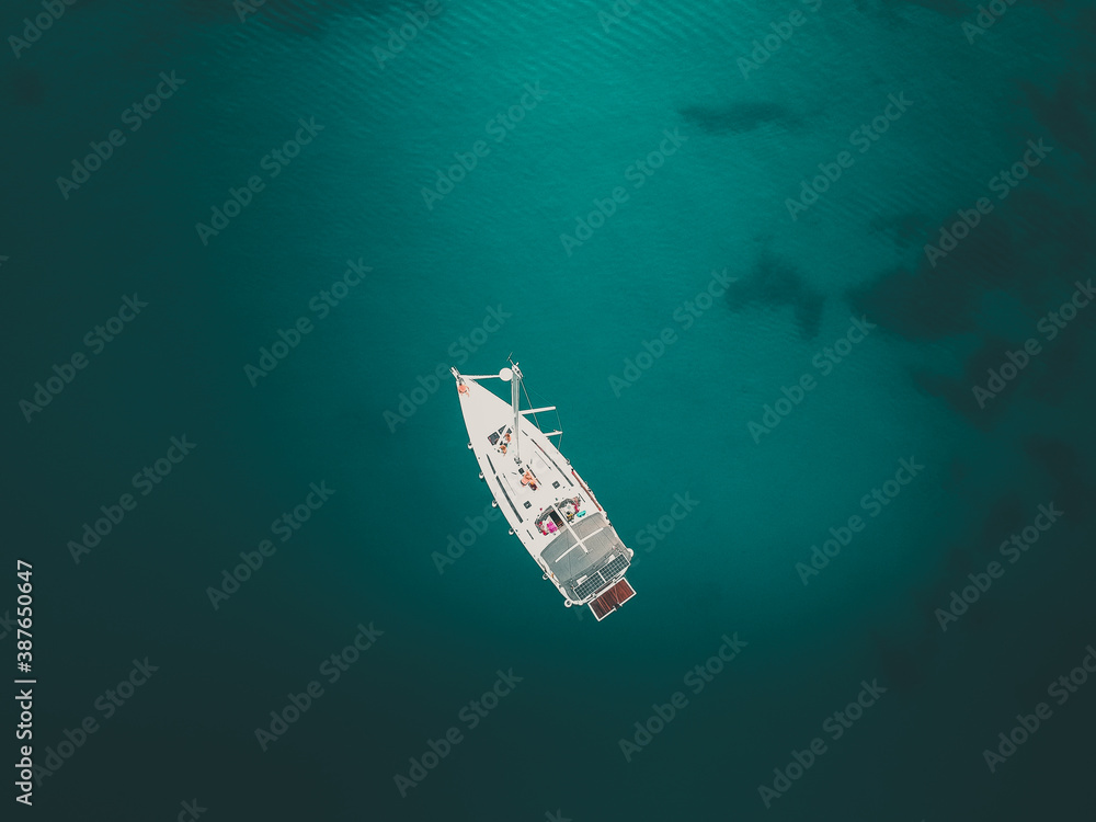 sailboat in the middle of mediterranean sea - aerial top down view