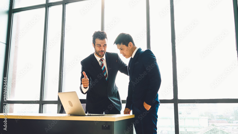 Two business people talk project strategy at office meeting room. Businessman discuss project planni