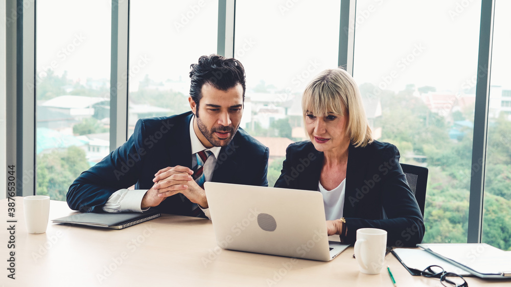 Two business people talk project strategy at office meeting room. Businessman discuss project planni