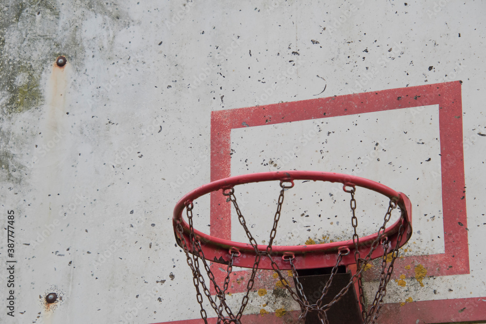 Old damaged basketball shield with chipped paint and board.